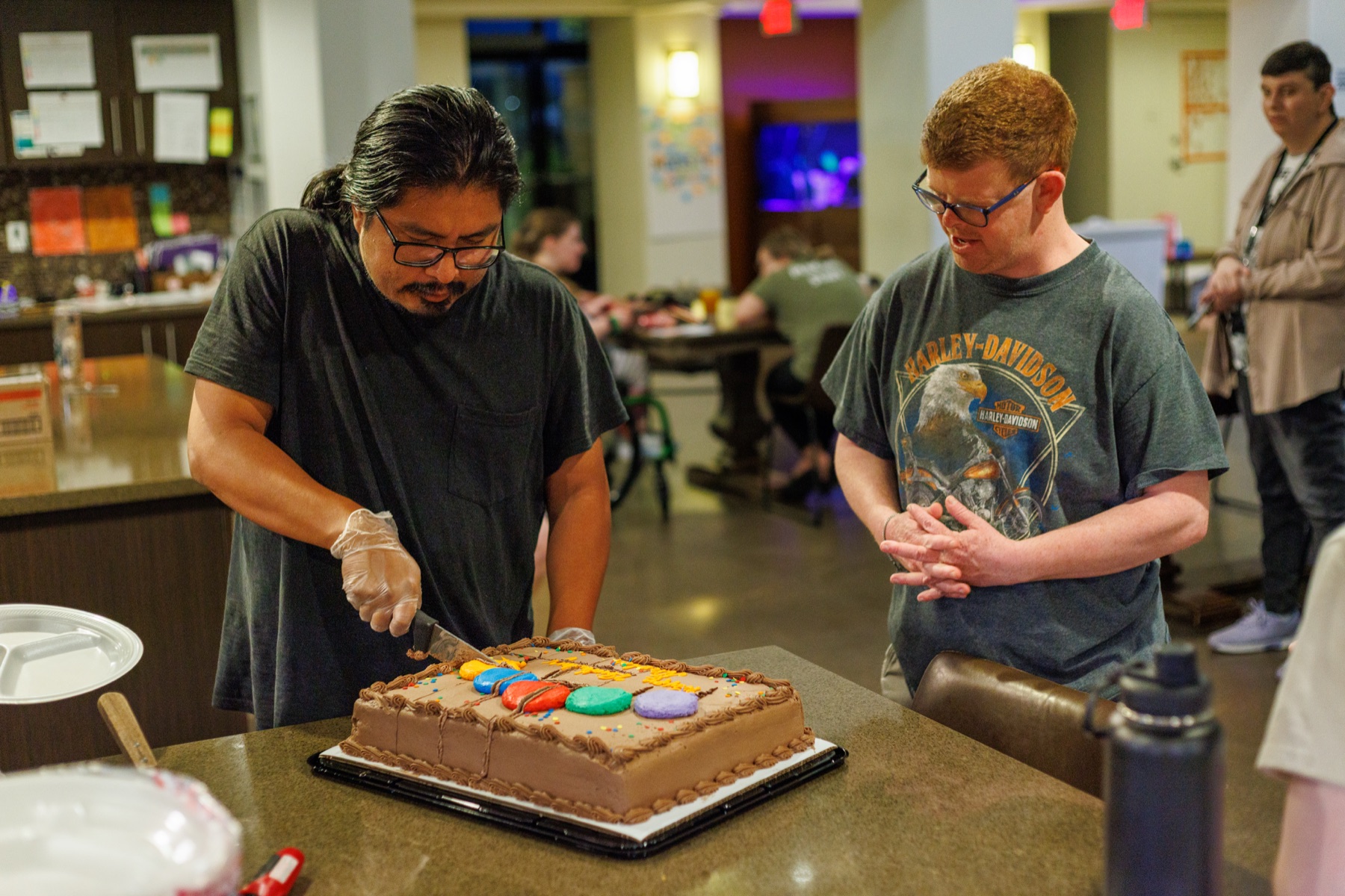 A community assistant and residents in the kitchen