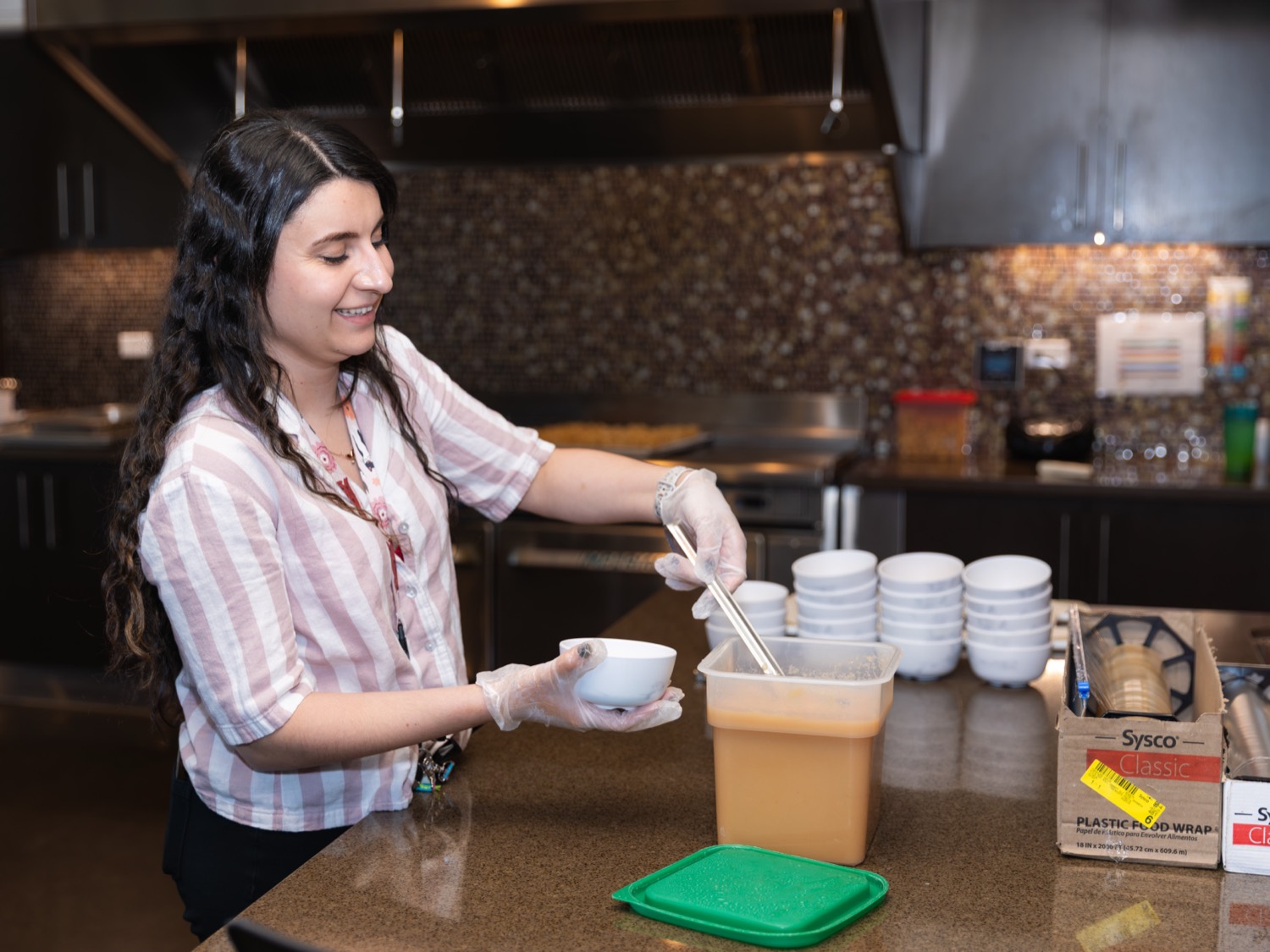 A resident working behind the coffee counter