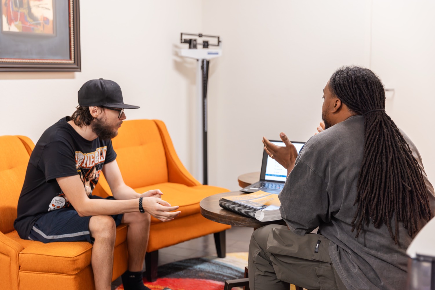 A resident and a life coach talking in the community lounge