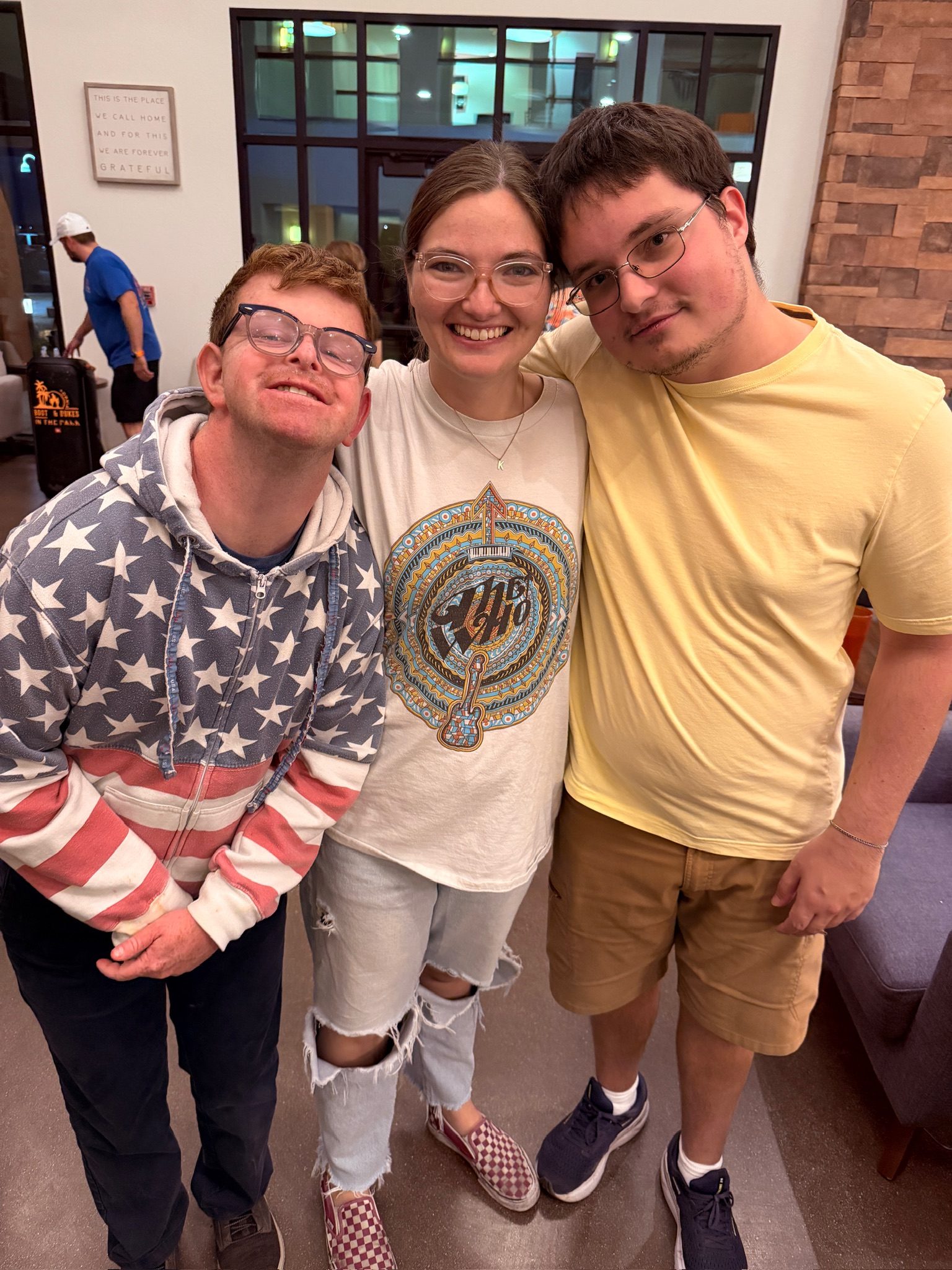 Three Treasure House residents together, arms around each other